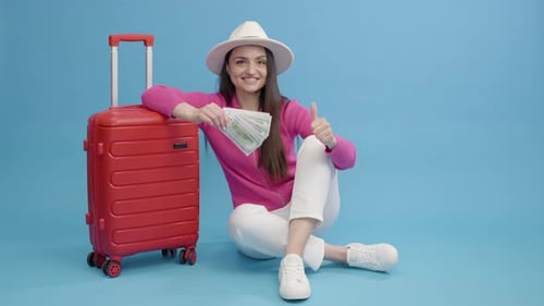 Smiling Woman With Luggage Holds Money For Travel