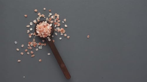 Pink Salt in Spoon on Gray Background