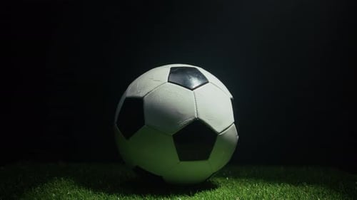 A Soccer Ball Rolls Across the Grass Ready for the Official Final at the Stadium