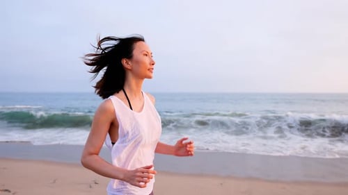 Attractive Woman jogging on the Beach