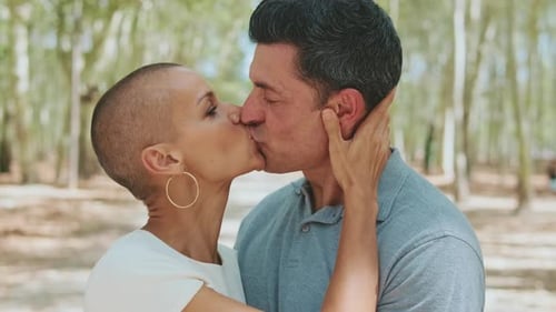 Close-up of happy married couple standing hugging and kissing each other