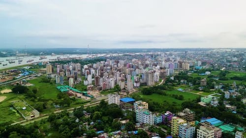 Aerial view of buildings situated alongside a river, showcasing the blend of urban architecture