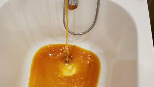The faucet in the bathroom is dispensing brown, dirty water that's been tainted with rust from the p