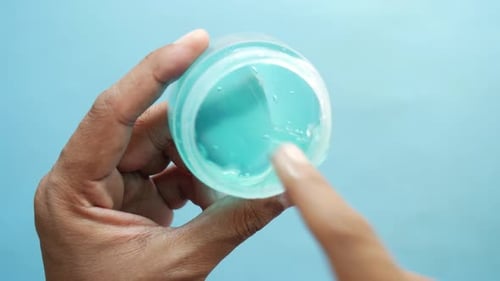 Close Up of Hand Testing Blue Gel