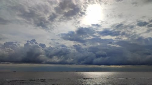 Ocean Under Dramatic Sky with Passing Clouds