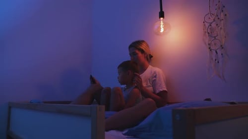 Mother and Child Bonding with Tablet at Night