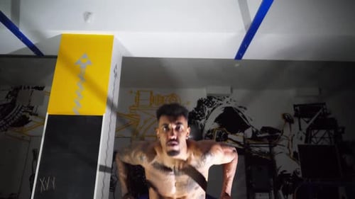 Muscular Afro American Sportsman Doing Push Ups on Parallel Bars at Modern Gym Strong African