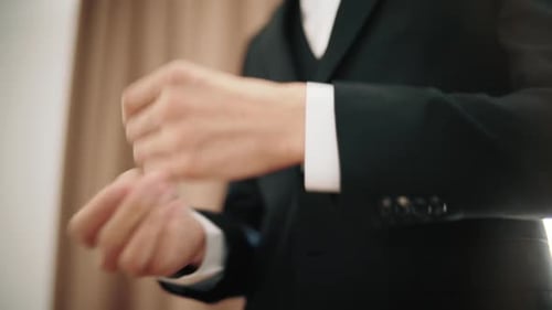 Elegant Business Man in Suit Straightening Sleeves of Shirt. Close Up