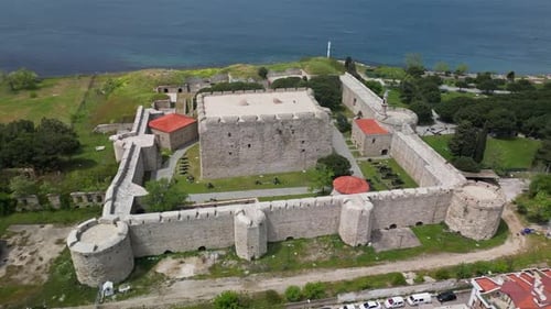Historic Stone Fortress with Towers By the Sea Seen From the Air