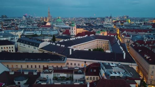 Vienna cityscape at dusk with historic buildings and illuminated streets, aerial view