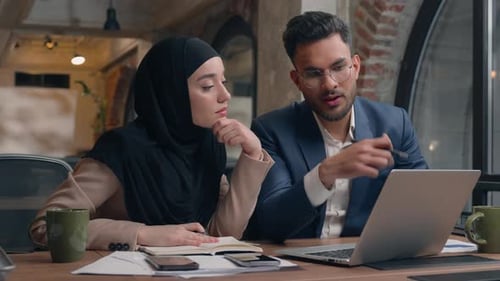 Business Colleagues Working Together on a Laptop