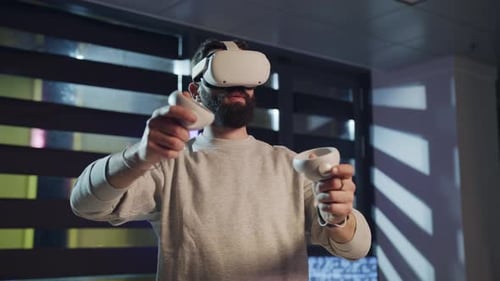 Man in VR Headset Stands Immersed in a Virtual World by a Window