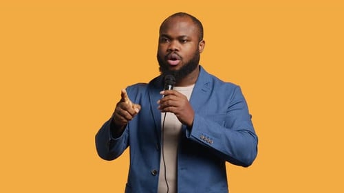 Motivational Speaker Holding Monologue Using Microphone Studio Background