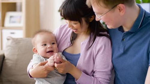 Happy family with baby bonding at home indoors