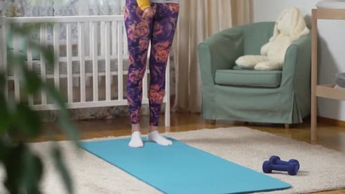 Mother Doing Lunges With Baby in Arms