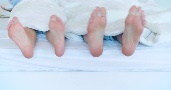 Couple Wiggling Feet in Bed Under White Sheets, People Stock Footage ft ...