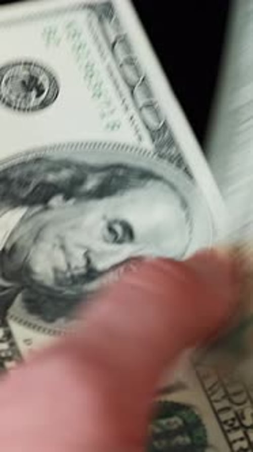 Close up of male hands counting money. Vertical video. Man counts dollar bills