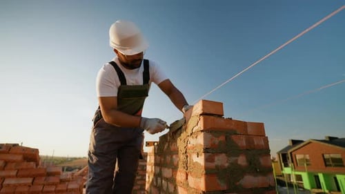 Indian Builder Carefully Constructs a Residential Wall