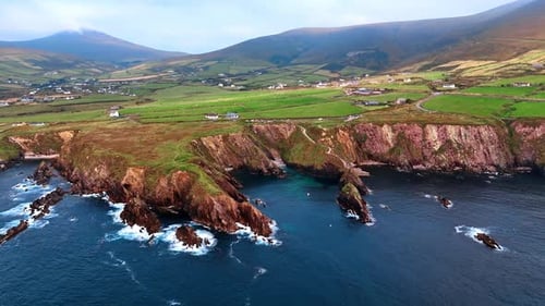 High cliff descending into the waters of the Atlantic Ocean.