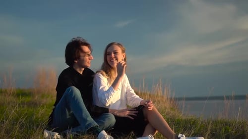 Young Couple Enjoying Nature at Sunset