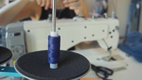 Thread Spool Placed on Sewing Machine at Workplace