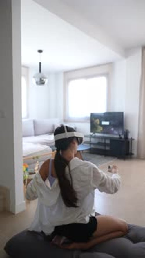 Woman Wearing VR Headset Sits Cross Legged Indoors