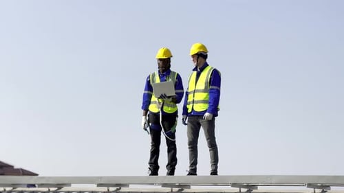 Technician installing solar cell. Installation and maintenance of solar cells on rooftop.