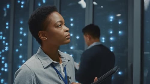 Woman Using Tablet in Futuristic Server Room