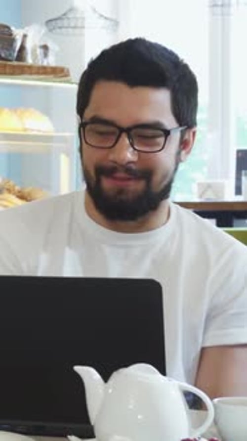 Young People Enjoying Lively Conversation Over Coffee at a Cozy Cafe
