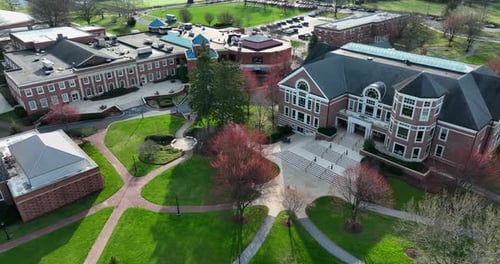 American college university campus grounds. Exterior of red brick buildings and architecture in spri