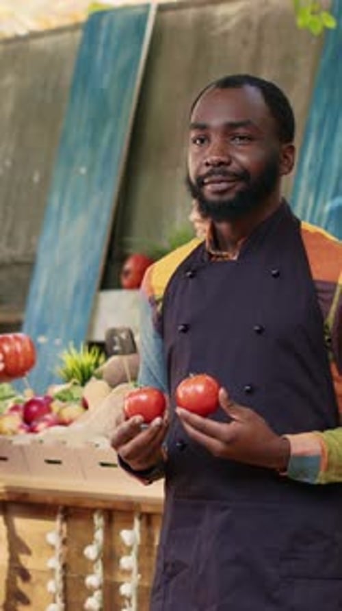 Vertical Video Male Stand Holder with Apron Holding Ripe Bio Produce