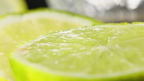 Freshly sliced lime, Tracking out along lime texture pattern, Slow motion macro shot