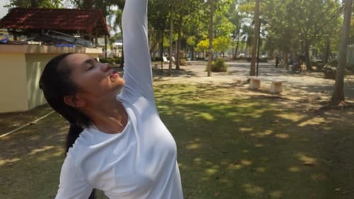 Close Up of Woman Practicing Yoga Outdoors in Morning Sunlight