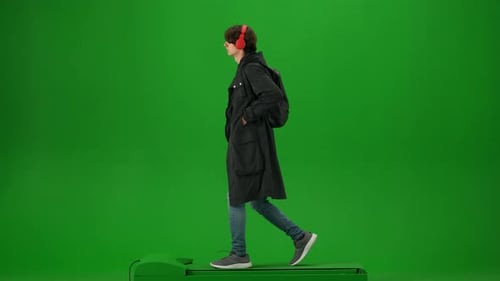 Portrait of Traveler Isolated on Chroma Key Green Screen Background Young Man with Backpack in Coat