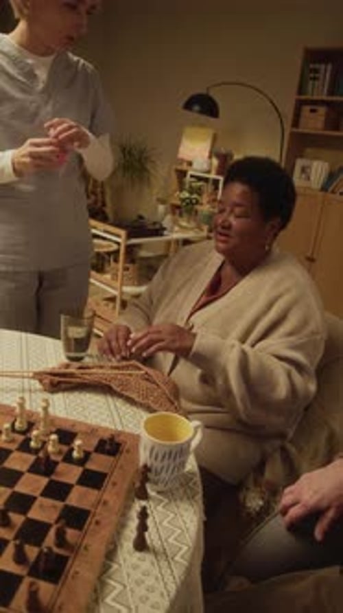 Female Caregiver Bringing Medication to Senior Nursing Home Resident