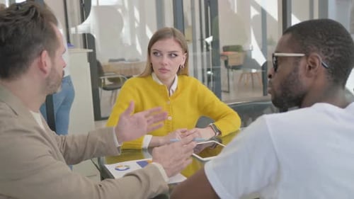 Young Entrepreneur Talking During Meeting in Office