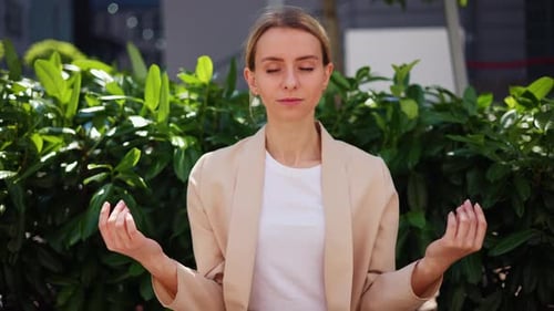 Beautiful Woman Sitting on Wooden Bench Relax Meditates in Morning Park