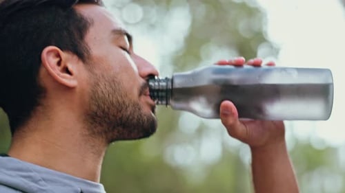 Athletic Man Drinking Water Outside