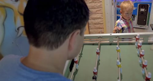 Father and Son Playing Foosball in Arcade