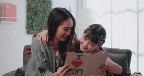 Happy Girl Giving Mother Homemade Birthday Card