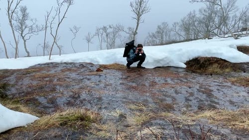Photographer Taking Pictures in Winter Landscape