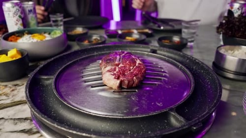 close-up of delicious appetizing juicy piece of raw meat being grilled in Korean restaurant