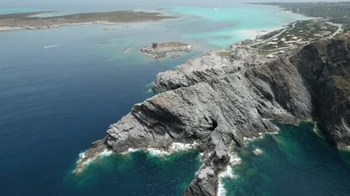 Aerial view fly over drone over sea cliff with powerful sea waves and torquoise water Beach sand in