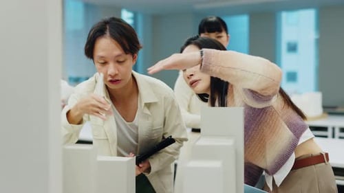 Architecture, model and people with building prototype and discussion for floor plan and project