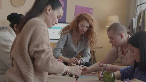 Team of Feminists Drawing Protest Banner during Club Gathering