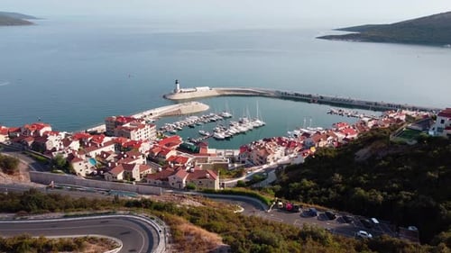Aerial view of luxury sailing yachts and boats in yacht club near wooden piers. Top view of european
