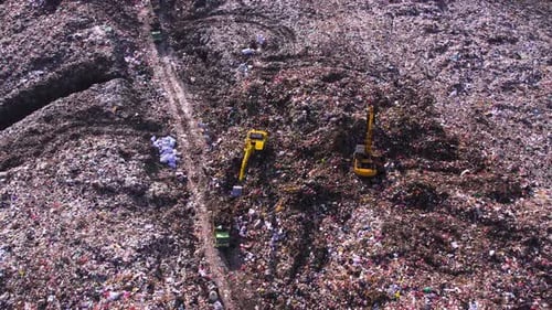 Aerial View of Vast Landfill with Heavy Machinery