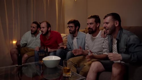 Five Friends Watch Television and Celebrate Together Indoors