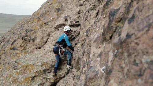 Man Athlette Climbing on the High Rock