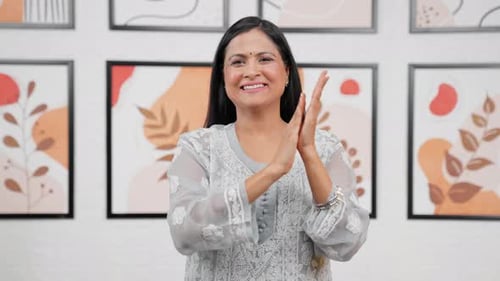 Smiling Woman Clapping Hands Indoors